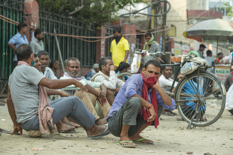  A group of daily wage workers chats among themselves as they wait to get work at Labour Chowk in Noida. Labour Chowk of Noida, a place where people come for work. They usually come in the morning at this hub. Labourers who come here are mostly mason, carpenters, painters, daily wage labourers, plumbers etc . There has been rising unemployment in India due to the nationwide lockdown due to covid-19. (Photo by Pradeep Gaur / SOPA Images/Sipa USA) 