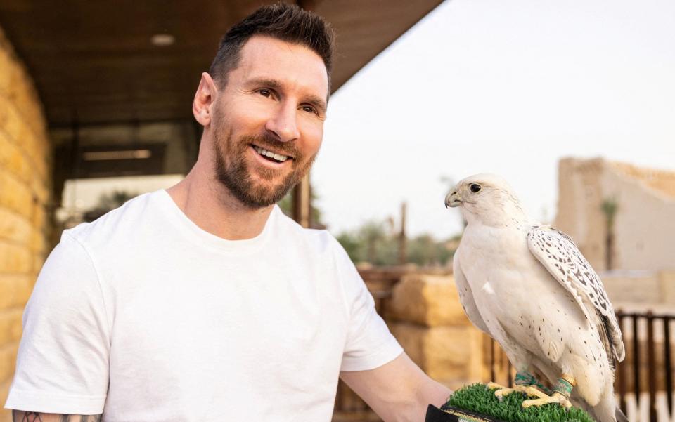 Lionel Messi poses with a falcon - Lionel Messi a £320m pawn in Saudi Arabia’s world domination plan - Reuters