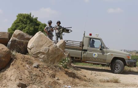 Saudi soldiers stand guard on a truck in Jizan on the border with Yemen November 3, 2014. REUTERS/Faisal Al Nasser