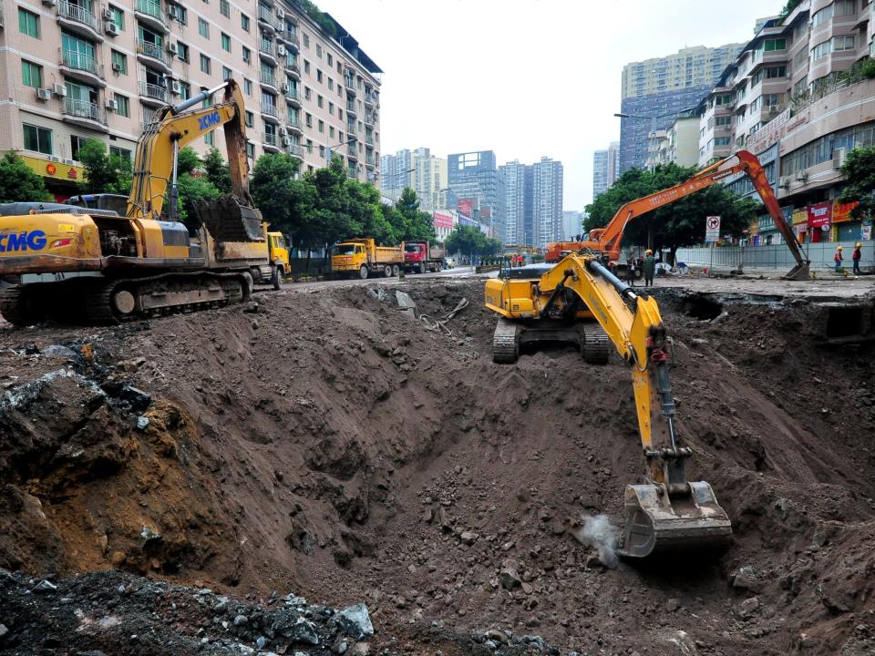 Excavators work on a sinkhole in Dazhou, China