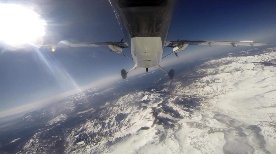 FILE - In this frame grab from file video, scientists from NASA's Jet Propulsion Laboratory fly over the Tuolumne River Basin of California's Sierra Nevada mountain range in a de Havilland Twin Otter plane to measure the snowpack on Sunday, March 23, 2014. The new Airborne Snow Observatory measures the snowpack's depth and water content with precision amid California's historical drought. Since December 2022, a parade of a dozen atmospheric storms have dumped so much snow up and down the Sierra that several ski resorts around Lake Tahoe have had to shut down multiple times. (AP Photo/Haven Daley, File)