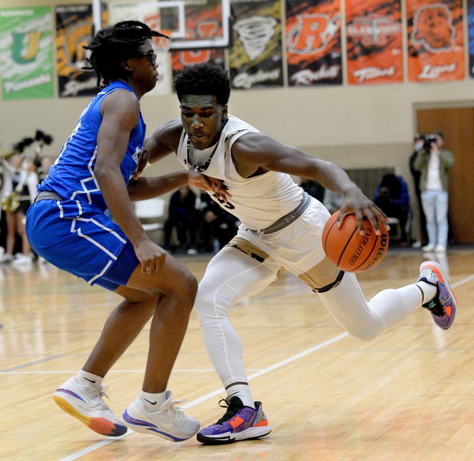 Sacred Heart-Griffin's Keshon Singleton drives the ball down the court against Decatur MacArthur on Friday.