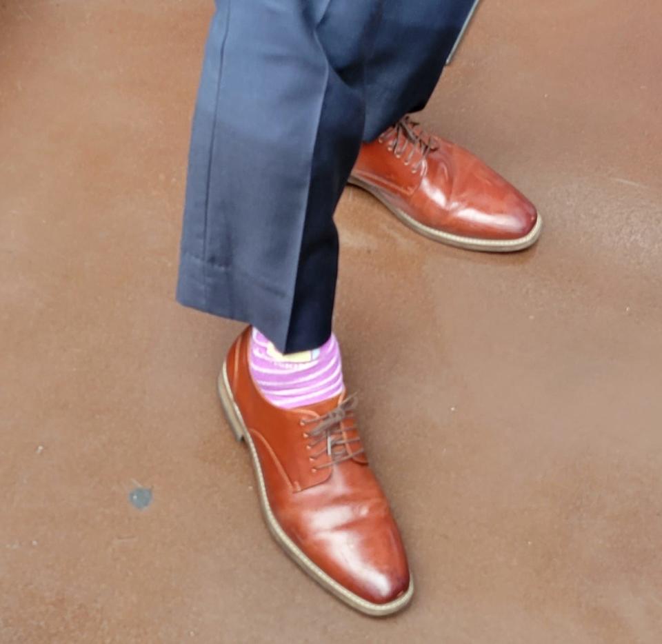 Kansas State quarterback Adrian Martinez shows off his purple and white socks Wednesday during Big 12 media days at AT&T Stadium in Arlington, Texas.