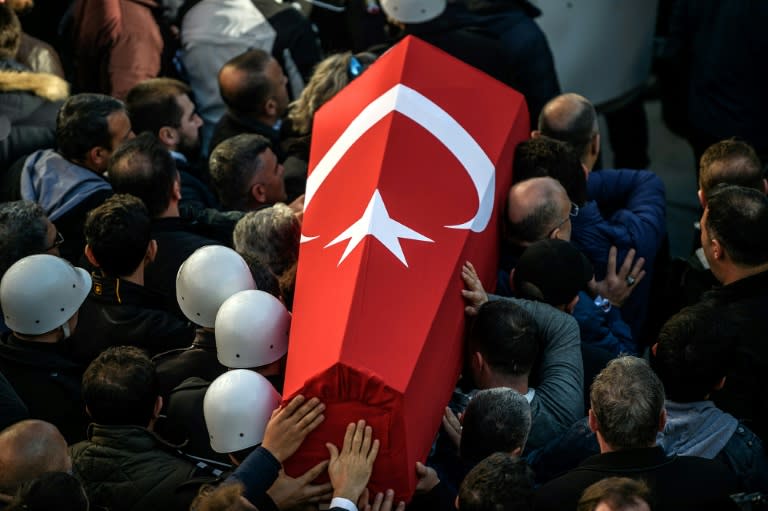 Turkish police carry the coffin of a fellow officer during a funeral ceremony at Istanbul's police headquarters on December 11, 2016