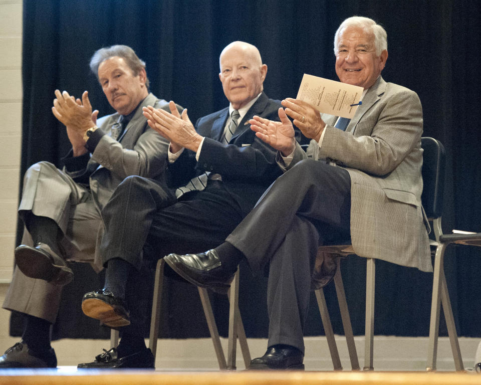 In a Monday, April 21, 2014 photo, U.S. Rep. Nick Rahall, right, applauds on stage with West Virginia School Building Authority representatives Dr. Mark Manchin, left, and Robert Holroyd during a school dedication event at Oakvale Elementary School in Princeton, W.Va. In a state where Republicans are breaking losing streaks that predate the Eisenhower administration, Rahall, a nearly 40-year Democratic House incumbent, is one of the GOP’s top targets. (AP Photo/Michael Shroyer)