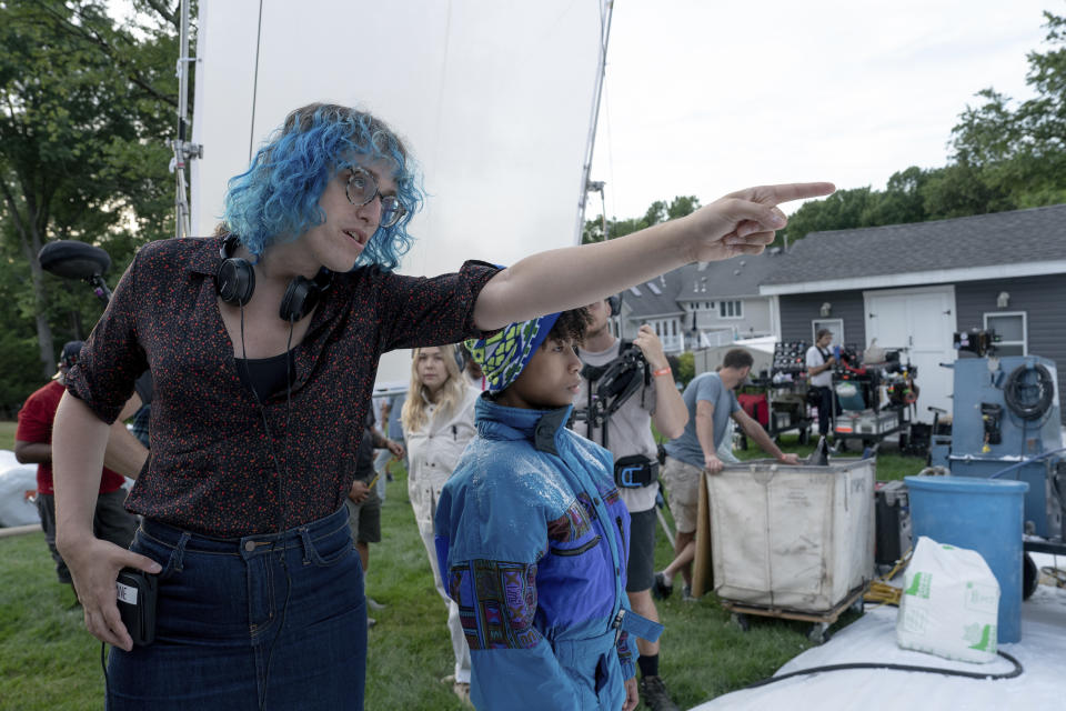 This image released by A24 shows writer-director Jane Schoenbrun, left, with actor Ian Foreman on the set of "I Saw the TV Glow." (A24 via AP)