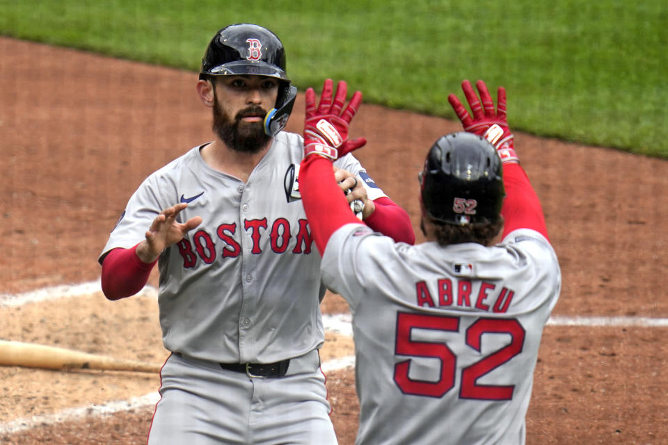 Boston Red Sox's Connor Wong, left, celebrates with Wilyer Abreu (52) after they scored on a single by teammate Reese McGuire off Pittsburgh Pirates relief pitcher Ryder Ryan during the fifth inning of a baseball game in Pittsburgh, Sunday, April 21, 2024. (AP Photo/Gene J. Puskar)