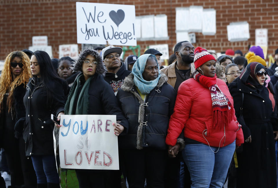 Protesters and family members of inmates hold hands while forming a prayer circle outside the Metropolitan Detention Center in New York on Sunday, Feb. 3, 2019. Some demonstrators protesting the lack of heat and electricity at the federal detention center in New York City attempted to enter the facility Sunday, and witnesses said guards drove them back with pushes, shoves and pepper spray. (AP Photo/Kathy Willens)