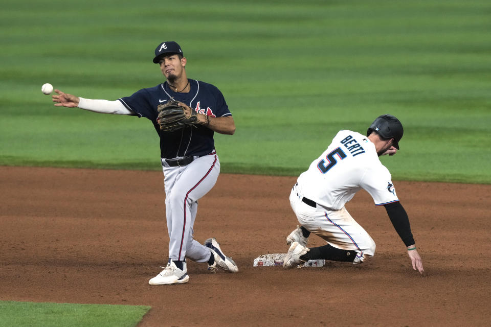 Miami Marlins shortstop Jon Berti (5) is out as Atlanta Braves shortstop Vaughn Grissom throws to first base to complete the double play during the sixth inning of a baseball game, Tuesday, May 2, 2023, in Miami. The Braves deleted the Marlins 6-0. (AP Photo/Marta Lavandier)