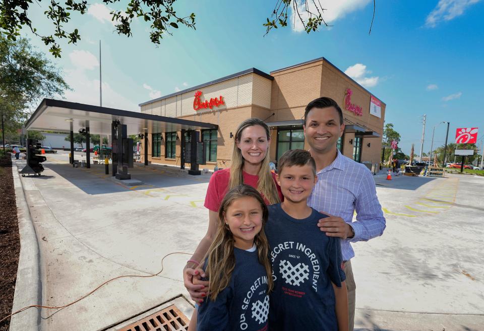 Franchisee Chris Kirby along with his wife ,Jenna, and children James, 10, and Elizabeth, 8, stand in front of their new Chick-fil-A restaurant as it nears completion on the northwest corner of International Speedway Boulevard and Williamson Boulevard in Daytona Beach. The new restaurant celebrated its grand opening on Thursday.