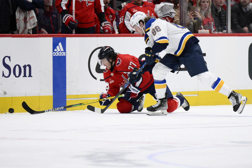 St. Louis Blues center Adam Gaudette (88) and Washington Capitals right wing T.J. Oshie (77) vie for the puck during the second period of an NHL hockey game Thursday, Jan. 18, 2024, in Washington. (AP Photo/Nick Wass)