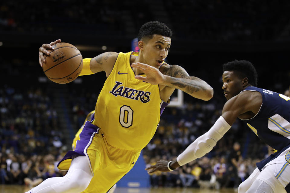 Lakers forward Kyle Kuzma beats Nuggets guard Malik Beasley off the dribble. (AP)