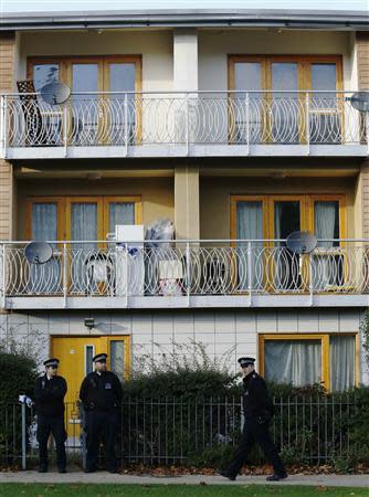 Police stand guard in front of a property in Lambeth, south London November 23, 2013. REUTERS/Luke MacGregor