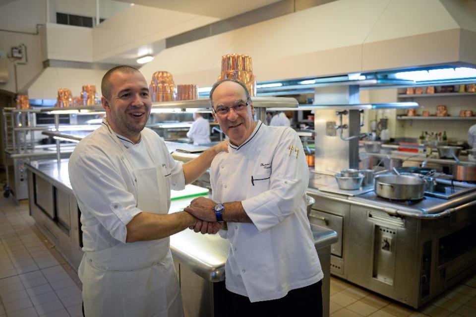 Bernard Vaussion, right, retiring head chef at the Elysee Palace, poses for photographers with his successor Guillaume Gomez, in the kitchens at the Elysee Palace in Paris, France, Thursday, Oct. 31, 2013. He’s fed five French presidents and peppered the steak tartare of some of the most powerful leaders in the world, but now France’s presidential chef is retiring after four decades of culinary service. Sixty-year-old Bernard Vaussion was filled with emotion while cooking his last lunch for the President Francois Hollande Thursday at the Elysee Palace _ a farewell meal that included raspberry millefeuille. (AP Photo/Martin Bureau, pool)