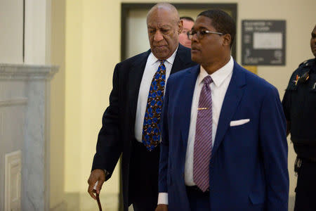 Bill Cosby (L) arrives at the Montgomery County Courthouse with his spokesperson Andrew Wyatt to attend his sexual assault retrial in Norristown, Pennsylvania, U.S. April 24, 2018. Jessica Griffin/Pool via REUTERS