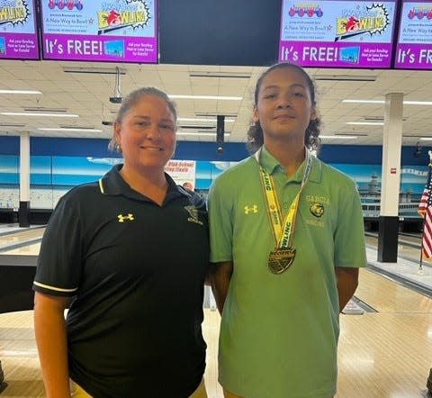 Dr. Joaquin Garcia's Jayden Brown wears his medal, posing next to his coach, Krystal Lamb on No. 2, 2023.