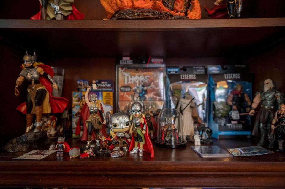 Jason Aaron displays Jane Foster action figures on various shelves in his home.