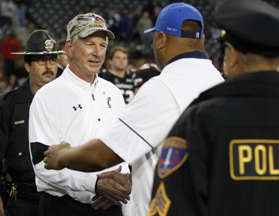 Cincinnati head coach Tommy Tuberville greets Brigham Young head coach Kalani Sitake following Cincinnati's 20-3 loss in an NCAA college football game, Saturday, Nov. 5, 2016, in Cincinnati. (AP Photo/Gary Landers)