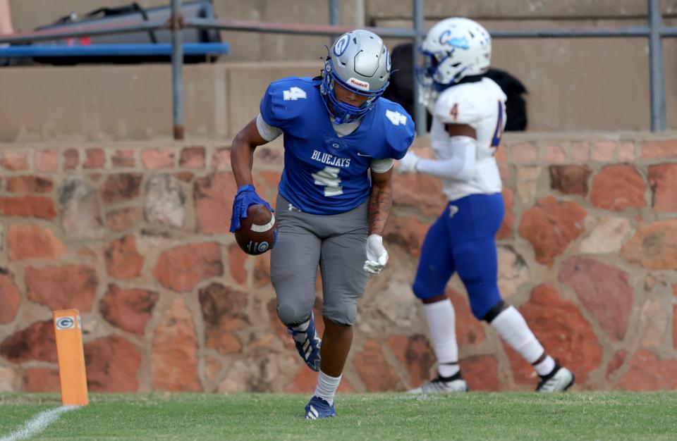 Guthrie's Jaylen Harper runs with the ball after a touchdown in front of Piedmont's Ethan Shelton during Friday's game in Guthrie.