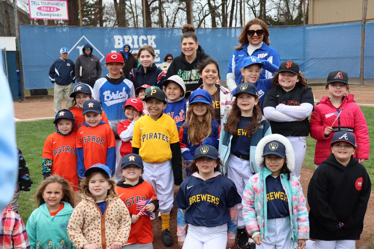 Brick Mayor Lisa Crate and New Jersey Little League District 18 Assistant Administrator Kellie McLeod are surrounded by all the girl Little League players during Brick Little League Opening Day ceremonies on April 13, 2024. This year marks the 50th anniversary of girls being allowed to play Little League baseball.