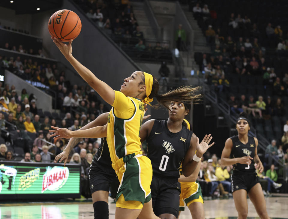 Baylor guard Jada Walker scores past Central Florida guard Laila Jewett during the first half of an NCAA college basketball game, Saturday, Jan. 20, 2024, in Waco, Texas. (Rod Aydelotte/Waco Tribune-Herald via AP)