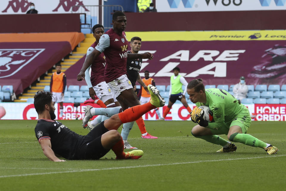 Chelsea's Olivier Giroud, left, misses a chance during the English Premier League soccer match between Aston Villa and Chelsea at the Villa Park stadium in Birmingham, England, Sunday, June 21, 2020. (Cath Ivill/Pool via AP)