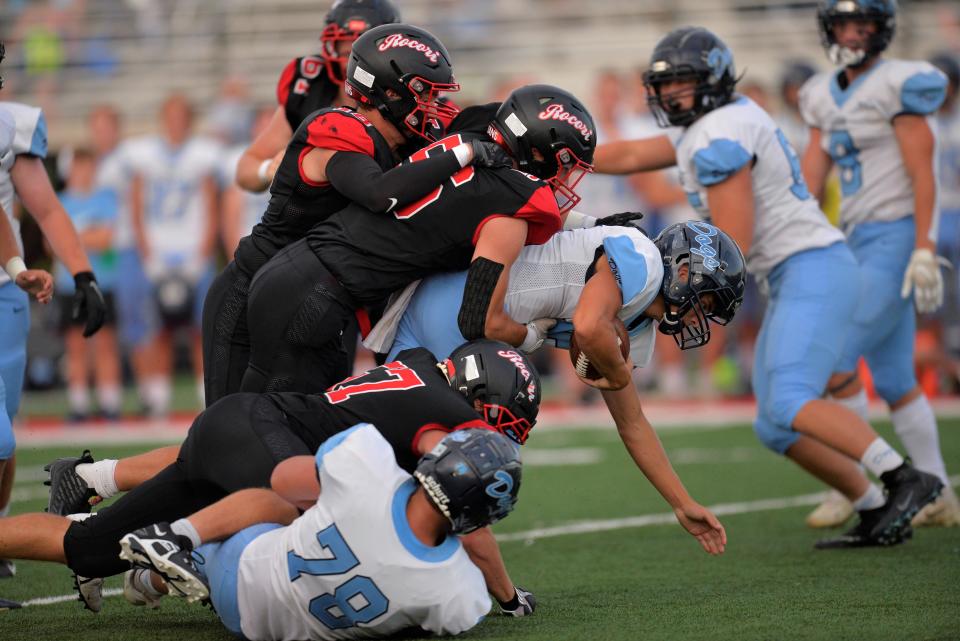 The ROCORI defense work together to sack the quarterback against Becker in the season opener on Friday, Aug. 26, 2022, at ROCORI High School.