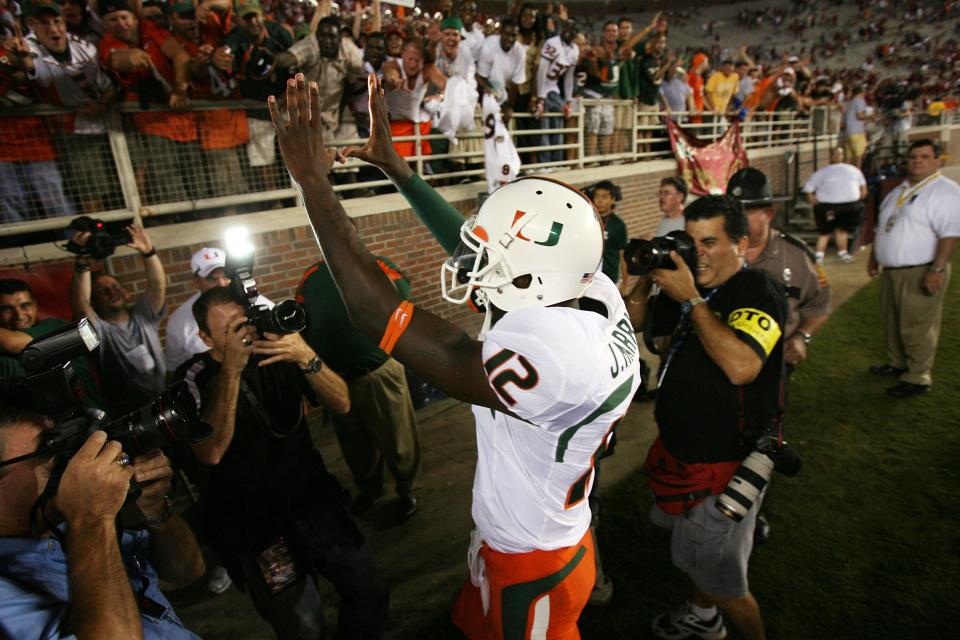 Quarterback Jacory Harris of the Miami Hurricanes celebrates victory over the Florida State Seminoles as he leaves the field at Doak Campbell Stadium on September 7, 2009 in Tallahassee, Florida. In the stands are Shelton and Wayne Douthett.