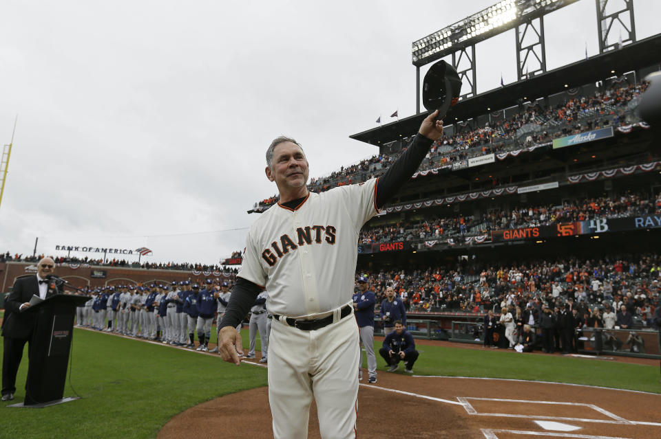 San Francisco Giants manager Bruce Bochy tips his cap to the crowd during introductions before an opening day baseball game against the Tampa Bay Rays, Friday, April 5, 2019, in San Francisco. Bochy, who is retiring at the end of the season, was honored in pregame ceremonies. (AP Photo/Eric Risberg)