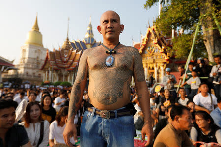 A devotee attends a religious tattoo festival at Wat Bang Phra, where devotees come to recharge the power of their sacred tattoos, in Nakhon Pathom province, Thailand, March 11, 2017. REUTERS/Jorge Silva