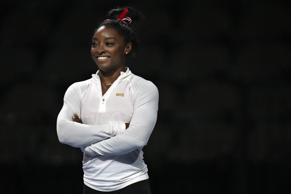 FILE - Simone Biles warms up during a practice session at the U.S. Classic gymnastics competition Friday, Aug. 4, 2023, in Hoffman Estates, Ill. Simone Biles is bringing back her Gold Over America Tour this fall, with a twist. This time, the guys are invited too. (AP Photo/Erin Hooley, File)