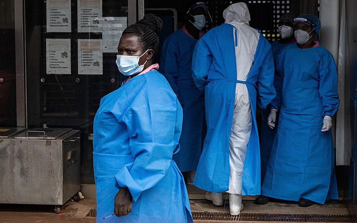 Members of the Ugandan Medical staff of the Ebola Treatment Unit stand inside the ward in Personal Protective Equipment (PPE) at Mubende Regional Referral Hospital in Uganda on September 24, 2022 - BADRU KATUMBA/AFP via Getty Images