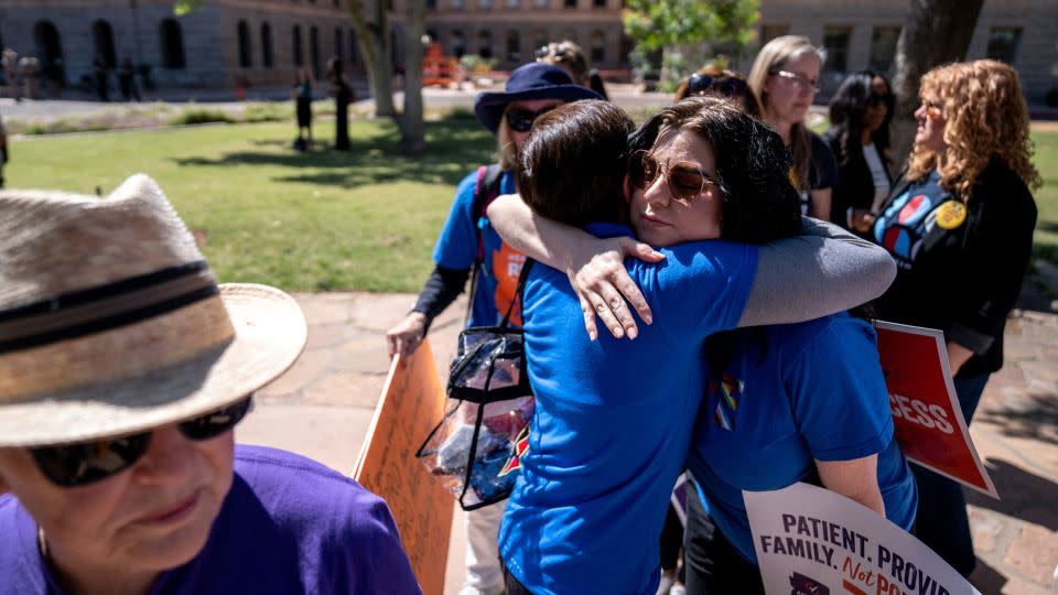 Abortion rights activists Marion Weich and Carolyn LaMantia embrace during a news conference Tuesday addressing the Arizona Supreme Court's ruling at the Arizona state Capitol in Phoenix. - Joel Angel Juarez/USA Today Network/Reuters