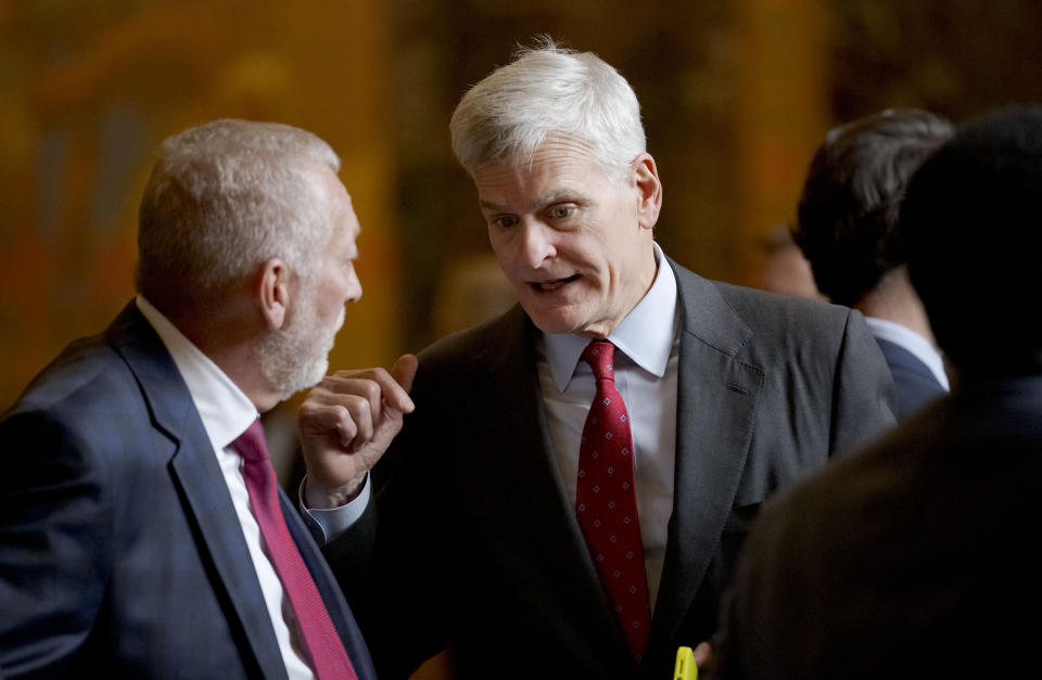 U.S. Senator Bill Cassidy (R-LA), right, arrives for the inauguration ceremony of Louisiana Republican Gov. Jeff Landry at the State Capitol building in Baton Rouge, La., Sunday, Jan. 7, 2024. The ceremony was moved because of forecasted rain on Monday, Jan. 8, the actual date Landry officially becomes governor. (AP Photo/Matthew Hinton)