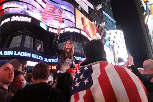 Draped in the American flag, Pedro Valerio, of Elizabeth, N.J. (R), and others react to the news of Osama Bin Laden’s death on May 2, in Times Square New York, US. The Al Qaeda kingpin was shot dead in a compound deep inside Pakistan in a night-time helicopter raid by US Navy SEALs on May 1, ending a decade-long manhunt for the mastermind of the 9/11 attacks. (AP Photo/Tina Fineberg)