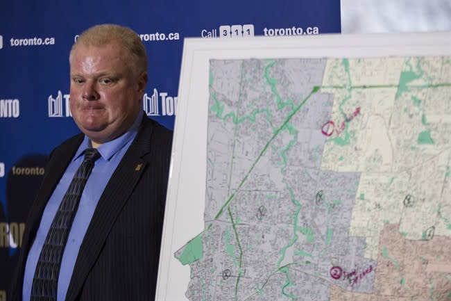 Toronto Mayor Rob Ford stands next to a map of the city at a news conference after an ice storm left over 250,000 customers across the city without power on Sunday, December 22, 2013. THE CANADIAN PRESS/Chris Young