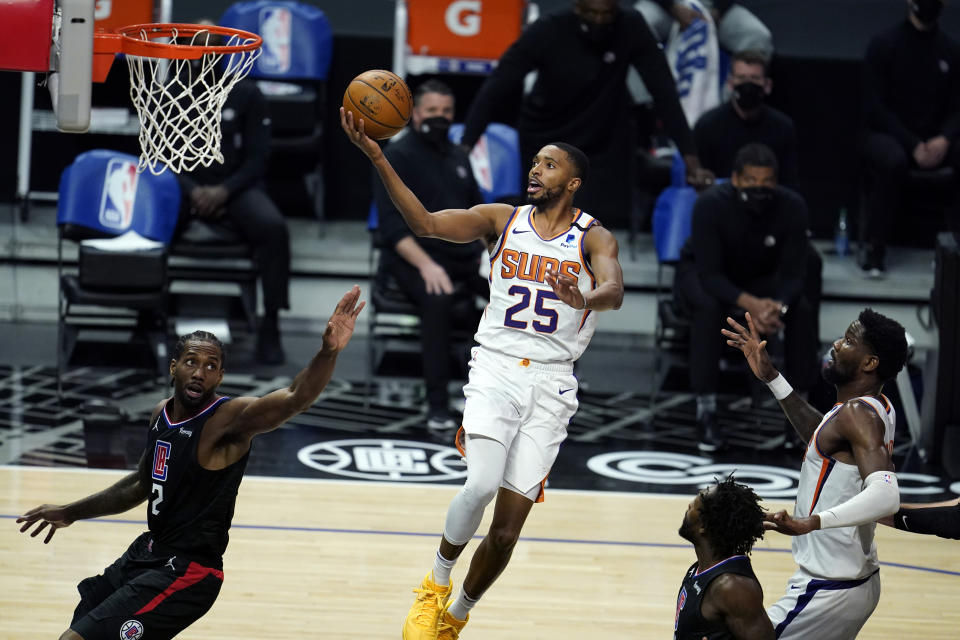 Phoenix Suns forward Mikal Bridges (25) scores over Los Angeles Clippers forward Kawhi Leonard, left, during the first half of an NBA basketball game Thursday, April 8, 2021, in Los Angeles. (AP Photo/Marcio Jose Sanchez)