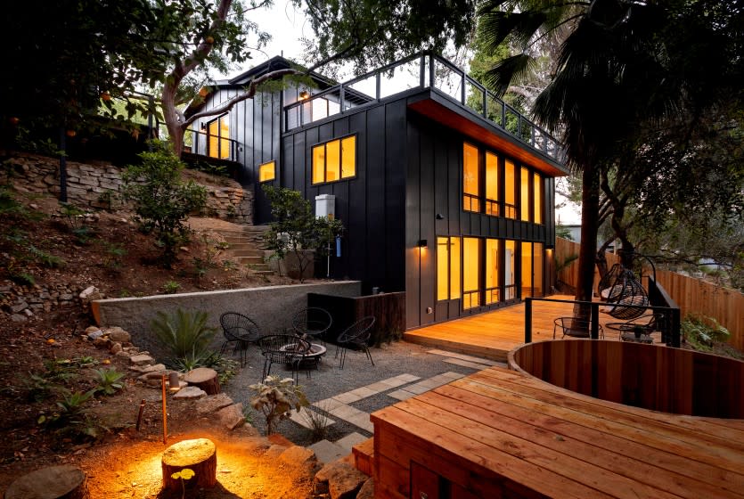 Listed for $2.149 million, the renovated home in Mount Washington presents as a modern treehouse with expansive decking that incorporates a number of mature trees into its design. Renovated by L.A.-based firm KeltnerCo, the three-bedroom, four-bathroom house has a casual feel with open-concept living areas, light hardwood floors and a mostly white-walled interior. The new-look kitchen is anchored by an island/breakfast bar topped with dark-hued Calacatta marble. The living room, which has a three-sided fireplace, sits nearby. Decking on multiple levels creates more than 700 square feet of additional space. A detached studio and a cedar spa lie elsewhere on the grounds.