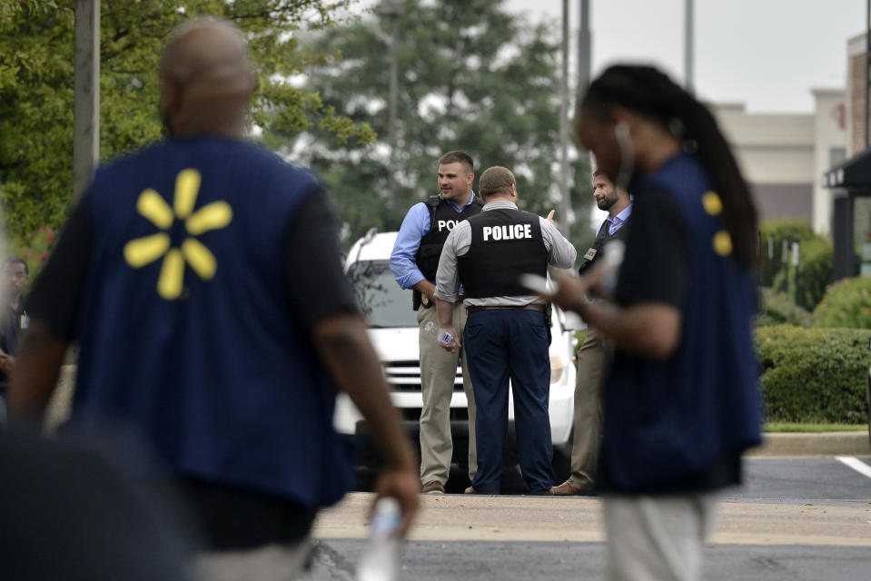 Police and employees gather in a nearby parking lot after a shooting at a Walmart store Tuesday, July 30, 2019 in Southaven, Miss. (AP Photo/Brandon Dill)