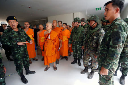 Soldiers and Buddhist monks are seen during an inspection of the Wat Phra Dhammakaya temple, in Pathum Thani province, Thailand March 10, 2017. REUTERS/Chaiwat Subprasom