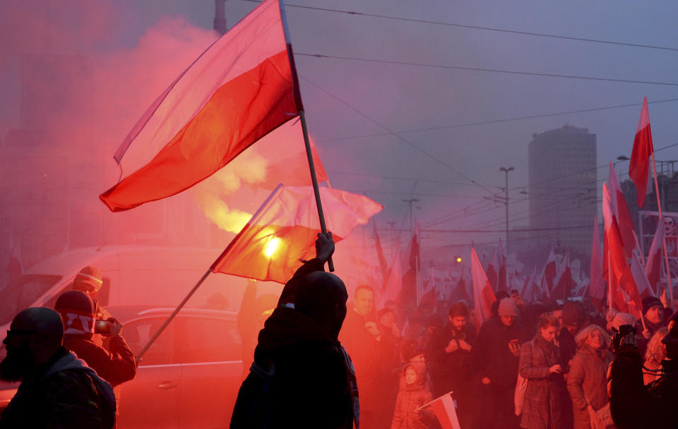 Marchers burn flares during the annual March of Independence organized by far right activists to celebrate 100 years of Poland's independence marking the nation regaining its sovereignty at the end of World War I after being wiped off the map for more than a century. (AP Photo/Alik Keplicz)