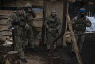 Ukrainian servicemen stand at a position close to the border with Belarus, Ukraine, Wednesday, Feb. 1, 2023. Reconnaissance drones fly several times a day from Ukrainian positions across the border into Belarus, a close Russian ally, scouring for signs of trouble on the other side. Ukrainian units are monitoring the 1,000-kilometer (650-mile) frontier of marsh and woodland for a possible surprise offensive from the north, a repeat of the unsuccessful Russian thrust towards Kyiv at the start of the war nearly a year ago. (AP Photo/Daniel Cole)