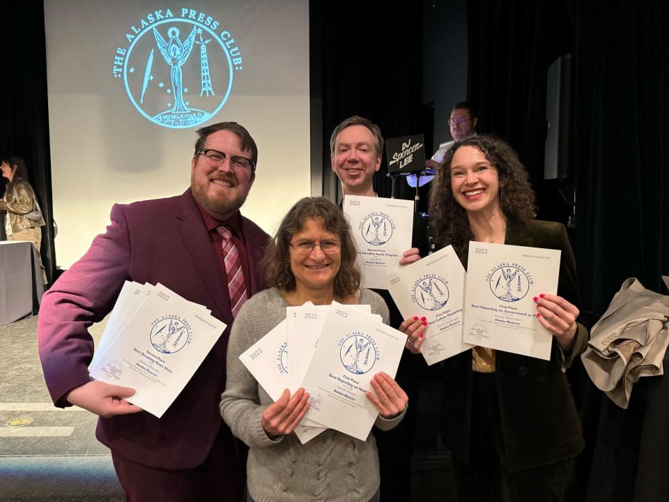 Alaska Beacon staff members James Brooks, Yereth Rosen, Andrew Kitchenman and Claire Stremple hold up the 13 awards the staff won in the Alaska Press Club's 2023 contest, on April 20, 2024 in Anchorage. (Photo by 49th State Brewing staff)