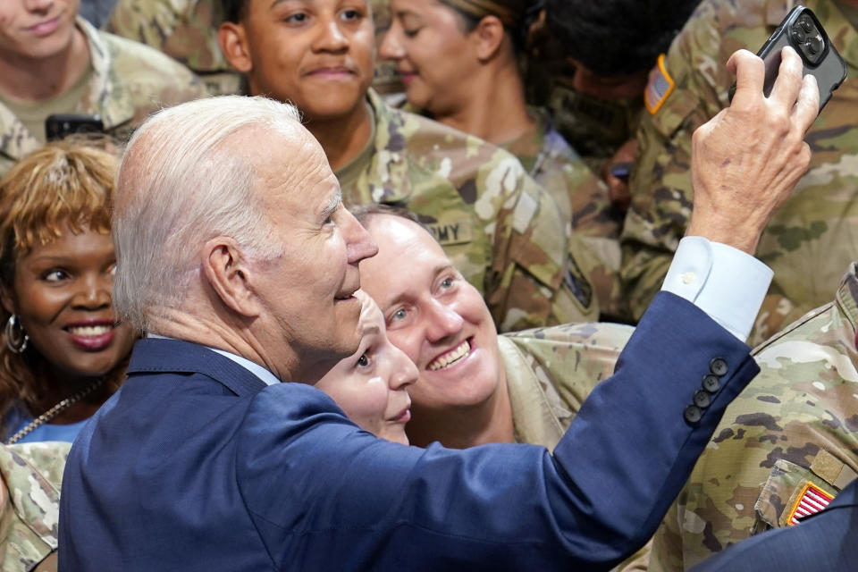 President Joe Biden takes a selfie during a visit to Fort Liberty, N.C., Friday, June 9, 2023. (AP Photo/Susan Walsh)