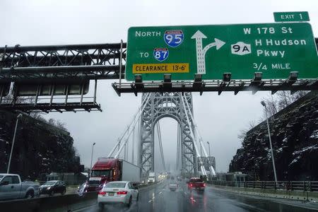 Cars make their way through the Washington bridge in New York November 26, 2014. REUTERS/Eduardo Munoz