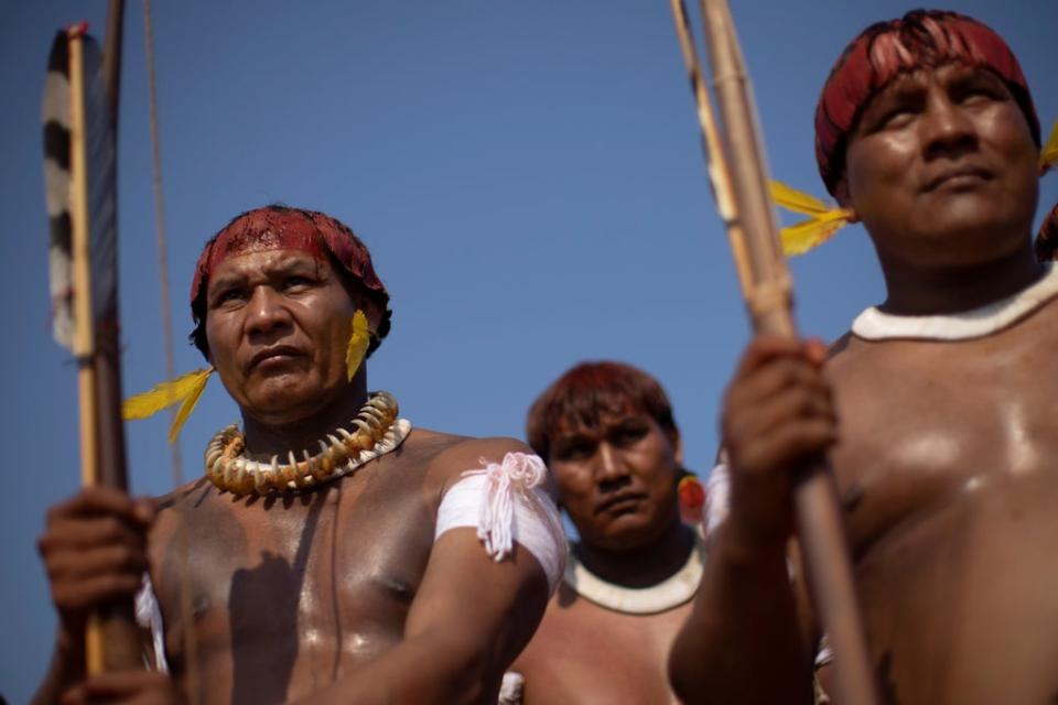 Tapi Yawalapiti and his brother Walako observe the struggles between indigenous men during the Kuarup funeral ritual (Reuters)