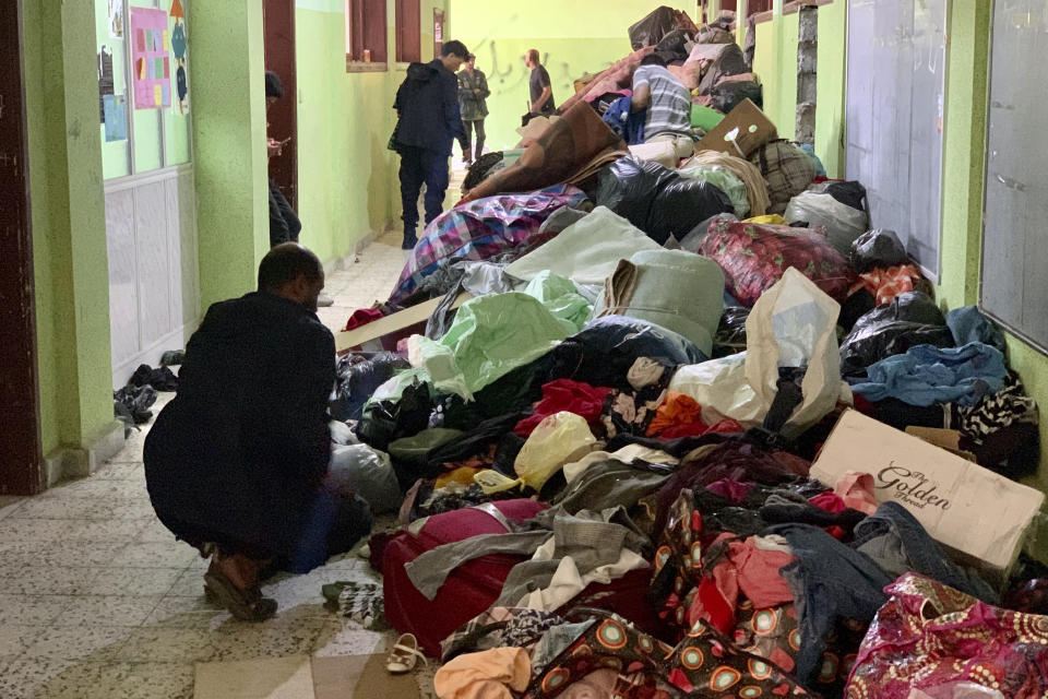 FILE - People deliver donated clothes to a flash flood-destroyed city of Derna, Libya, Saturday, Sept. 16, 2023. For many Libyans, the disastrous flooding that killed more than 11,000 people have fostered a sense of unity. The collective grief has morphed into a rallying cry of national unity in a country blighted by 12 years of conflict and division. (AP Photo/Yousef Murad, File)