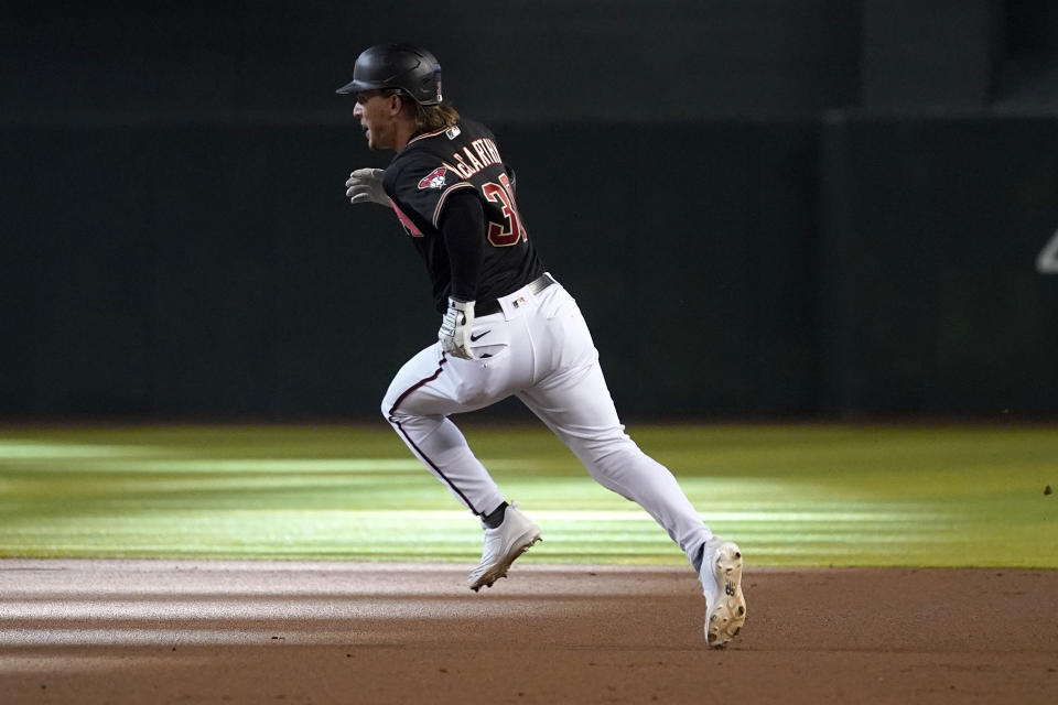 Arizona Diamondbacks' Jake McCarthy runs on an RBI triple during the second inning of a baseball game against the Los Angeles Dodgers, Saturday, May 28, 2022, in Phoenix. (AP Photo/Matt York)