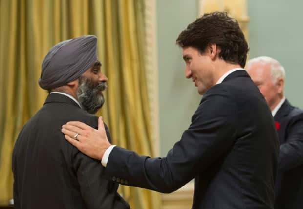 Minister of National Defence Harjit Singh Sajjan speaks to Prime Minister Justin Trudeau during a ceremony at Rideau Hall in Ottawa, Nov. 4, 2015. (THE CANADIAN PRESS - image credit)