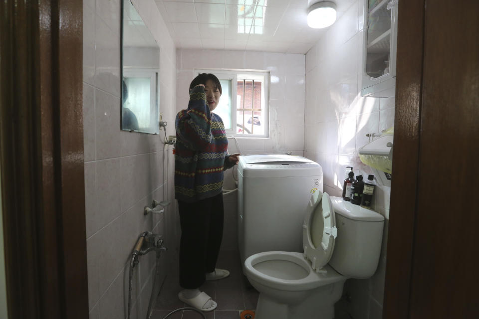 Kim Da-hye, a 29-year-old South Korean, explains about the restroom, in her semi-basement apartment in Seoul, South Korea, Saturday, Feb. 15, 2020. For many South Koreans, the image of a cramped basement apartment portrayed in the Oscar-winning film “Parasite” rings true, bringing differences in their social status to worldwide attention.(AP Photo/Ahn Young-joon)